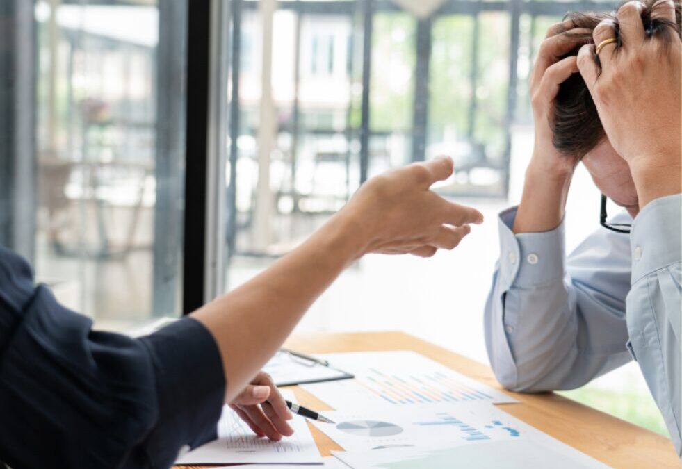 Business leader frustrated during sales review meeting, illustrating the impact of misaligned marketing and sales processes on long B2B sales cycles.