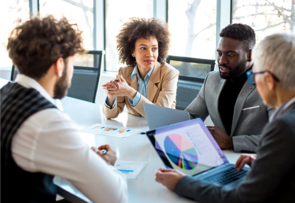Leadership team reviewing marketing attribution and executive dashboard metrics in a strategy meeting.