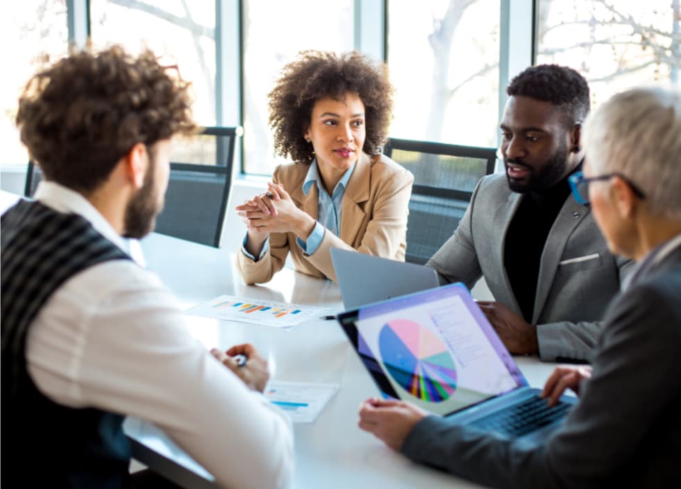 Leadership team reviewing marketing attribution and executive dashboard metrics in a strategy meeting.